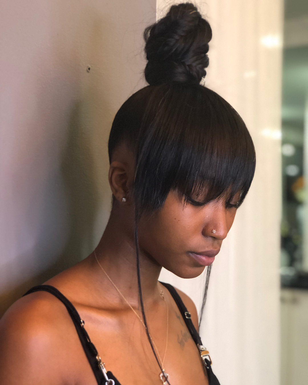 Sleek Black Topknot With Bangs