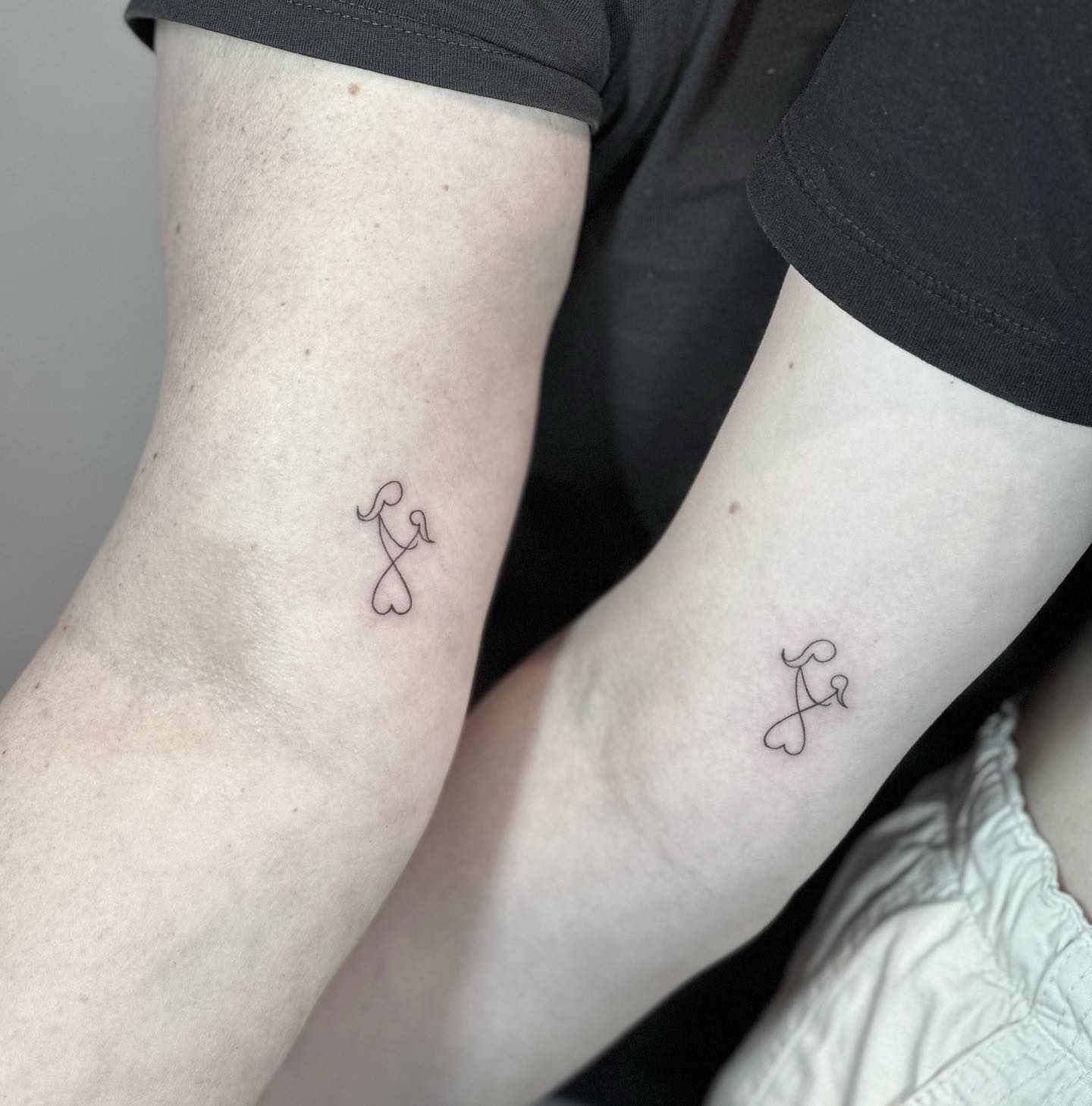 Mother and Daughter Tiny Symbol Tattoos on Arms