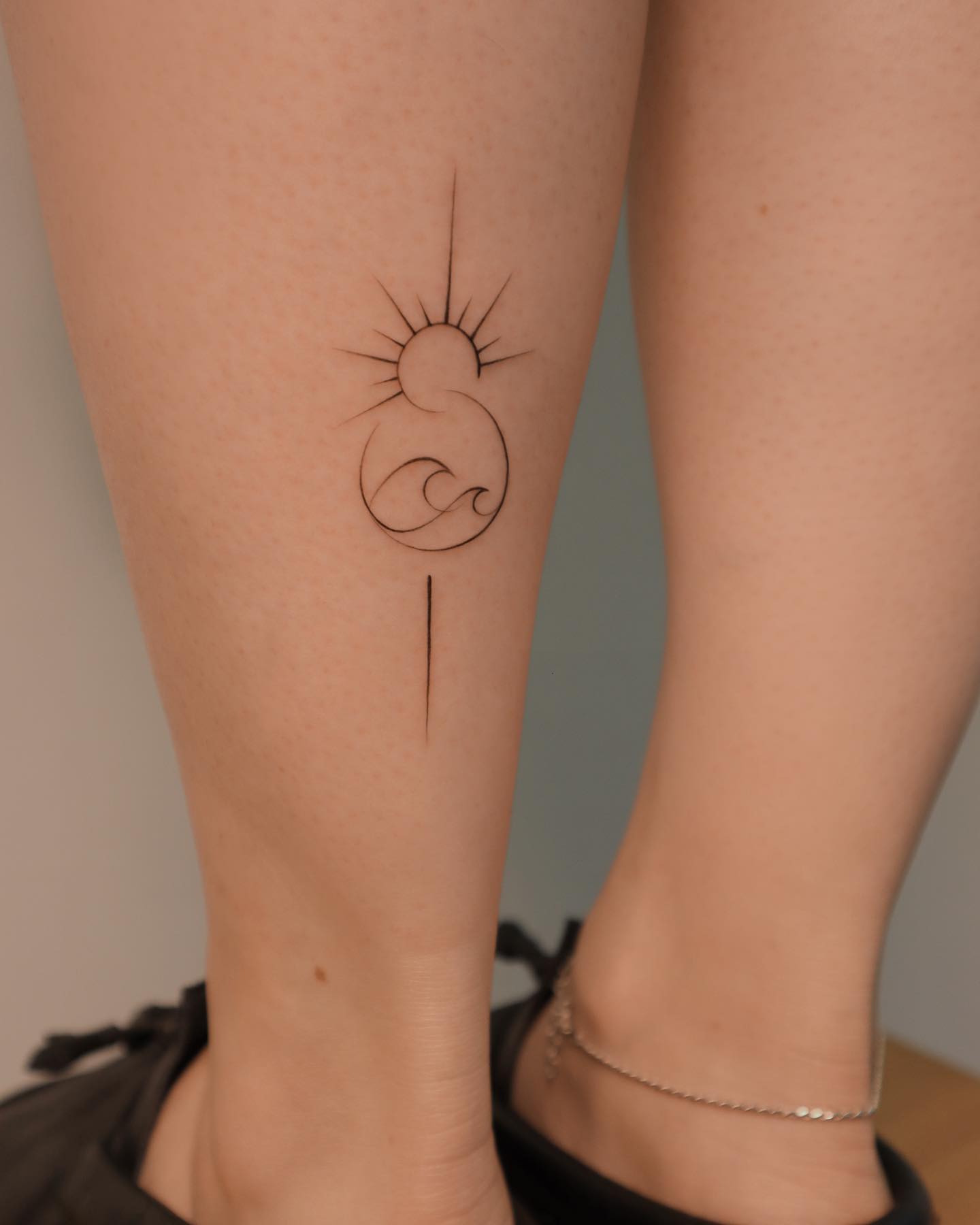 Simple Sun and Wave Tattoo on Leg