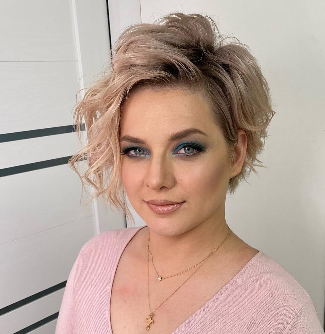 Asymmetrical Pixie Bob on Blonde Hair with Dark Roots