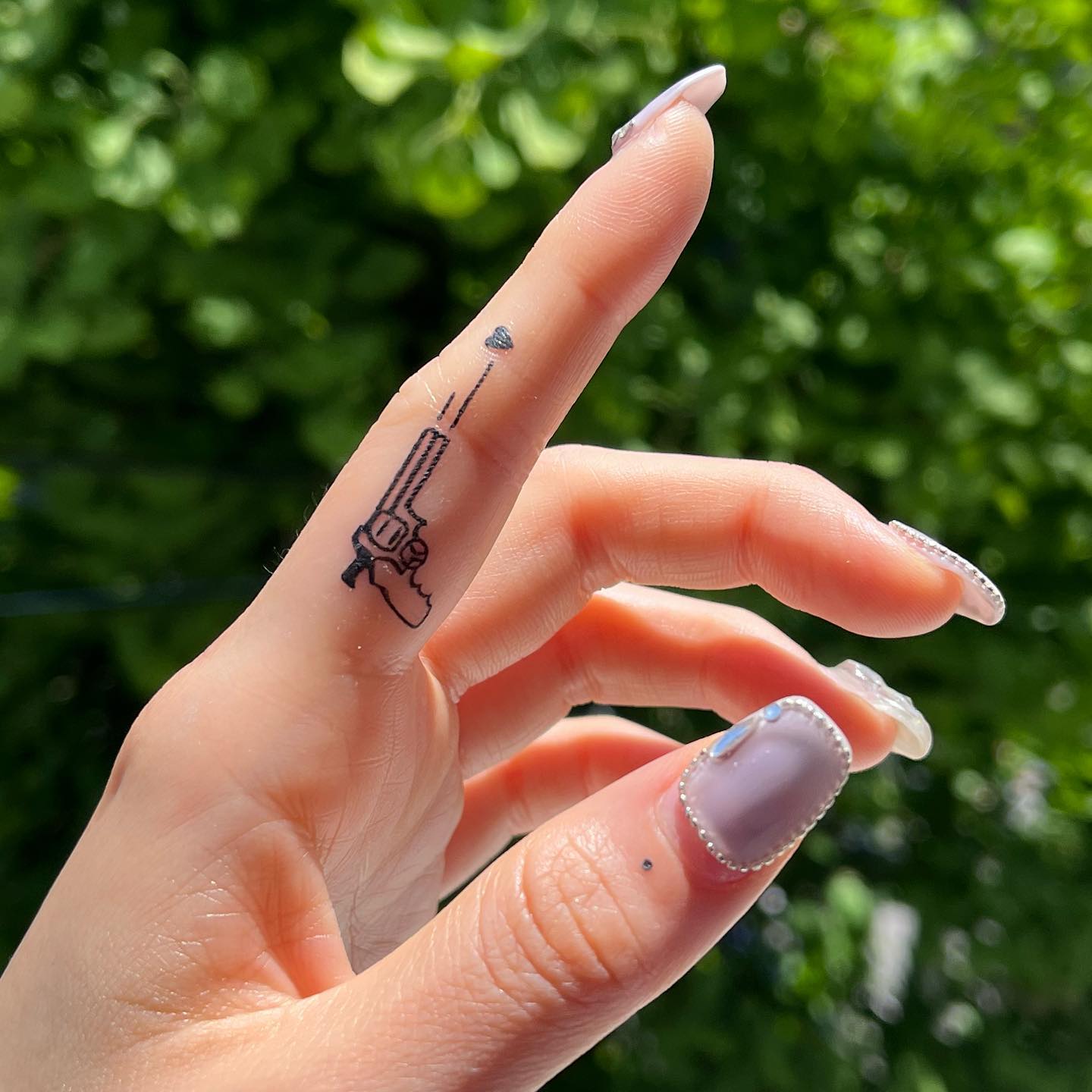 Gun Tattoo on Index Finger