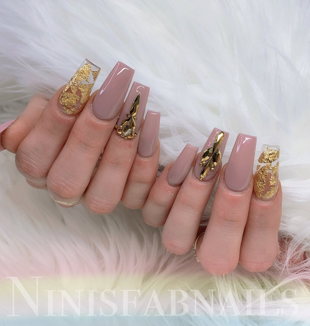 Cute nude nail pattern with quirky embellishments