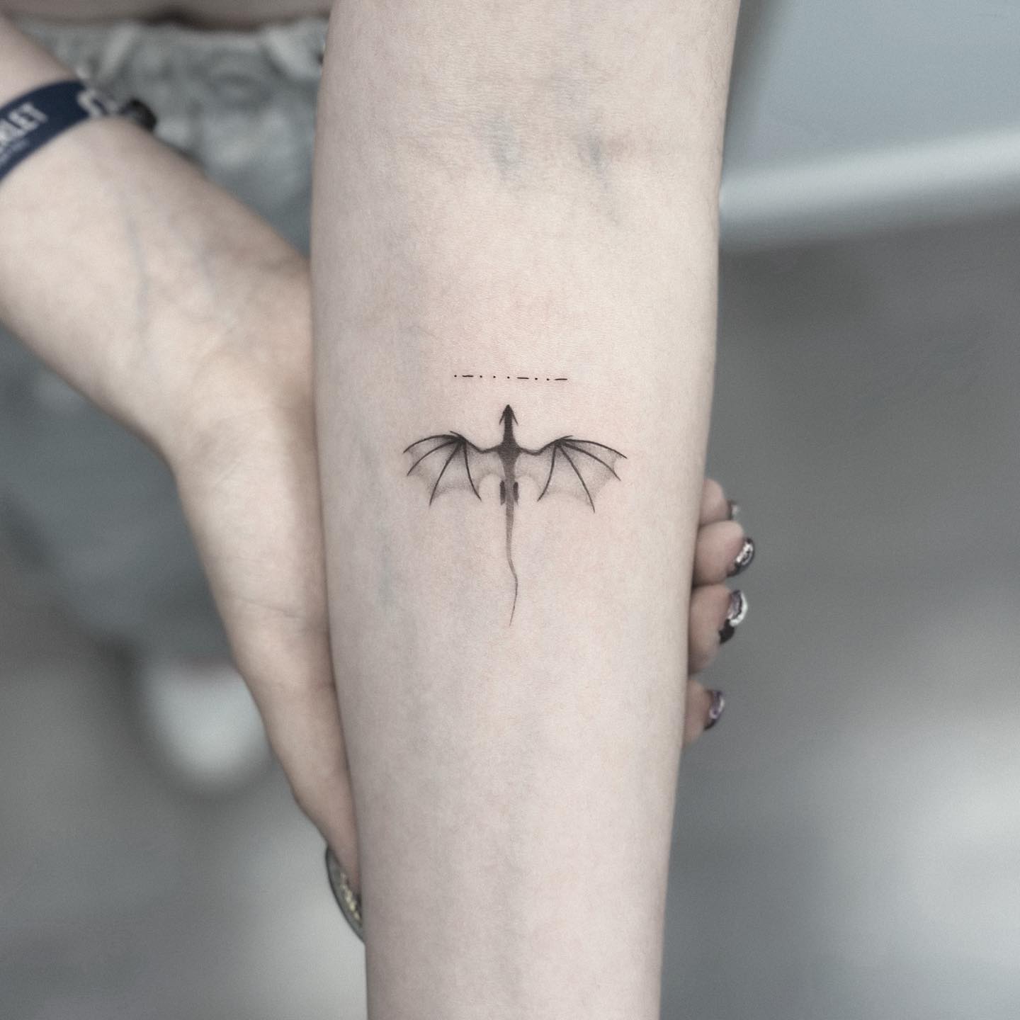 Small Black Dragon Tattoo on Arm