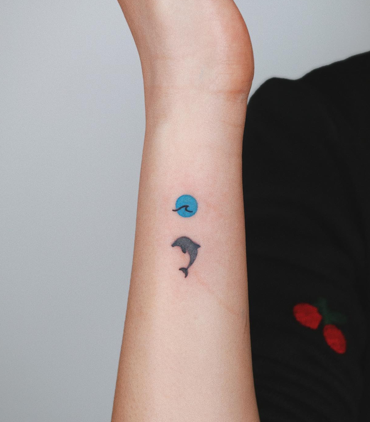 Hidden Semicolon Tattoo in the Form of Sun and Dolphin