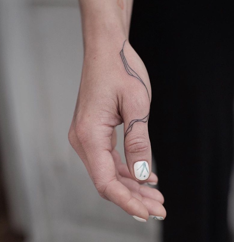 Abstract Tattoo on Thumb