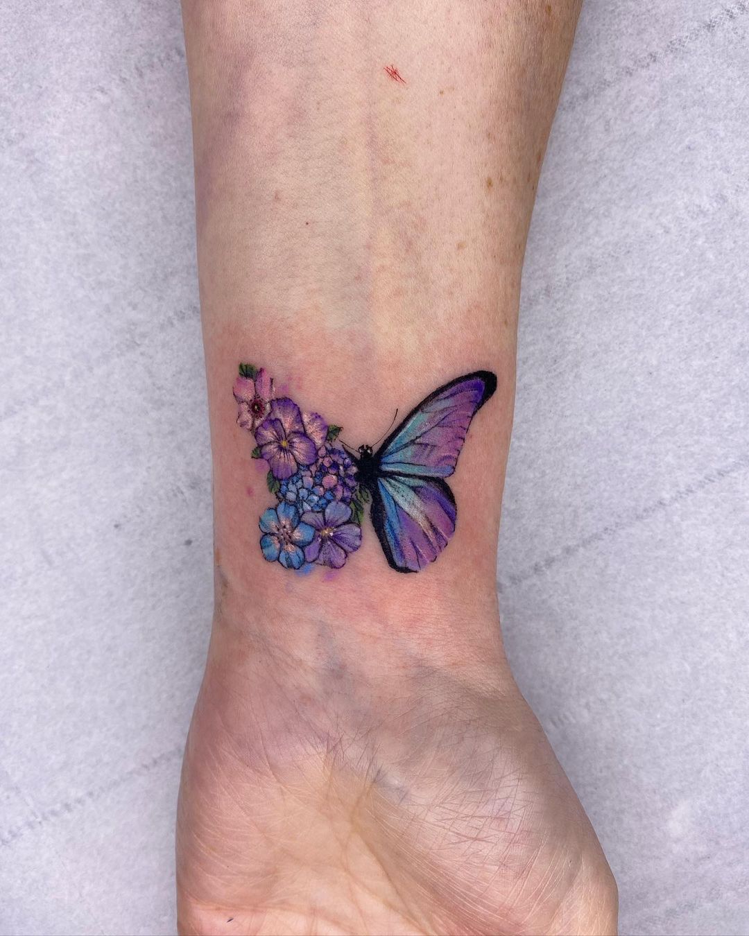 Purple Floral Butterfly Tattoo on Wrist