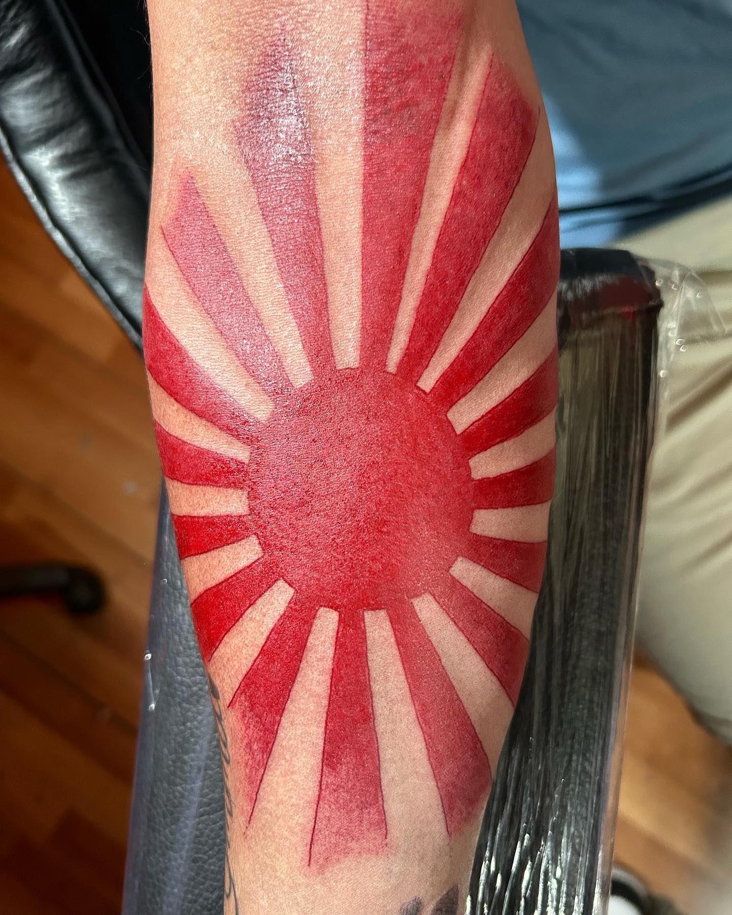 Red Sun Rays Tattoo on Arm