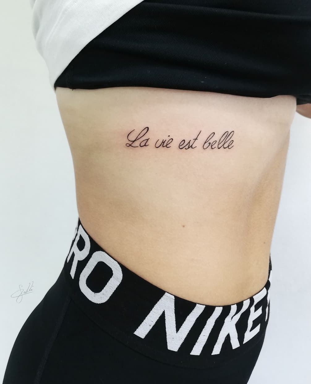 Black Ink Quote Tattoo on Side for Women