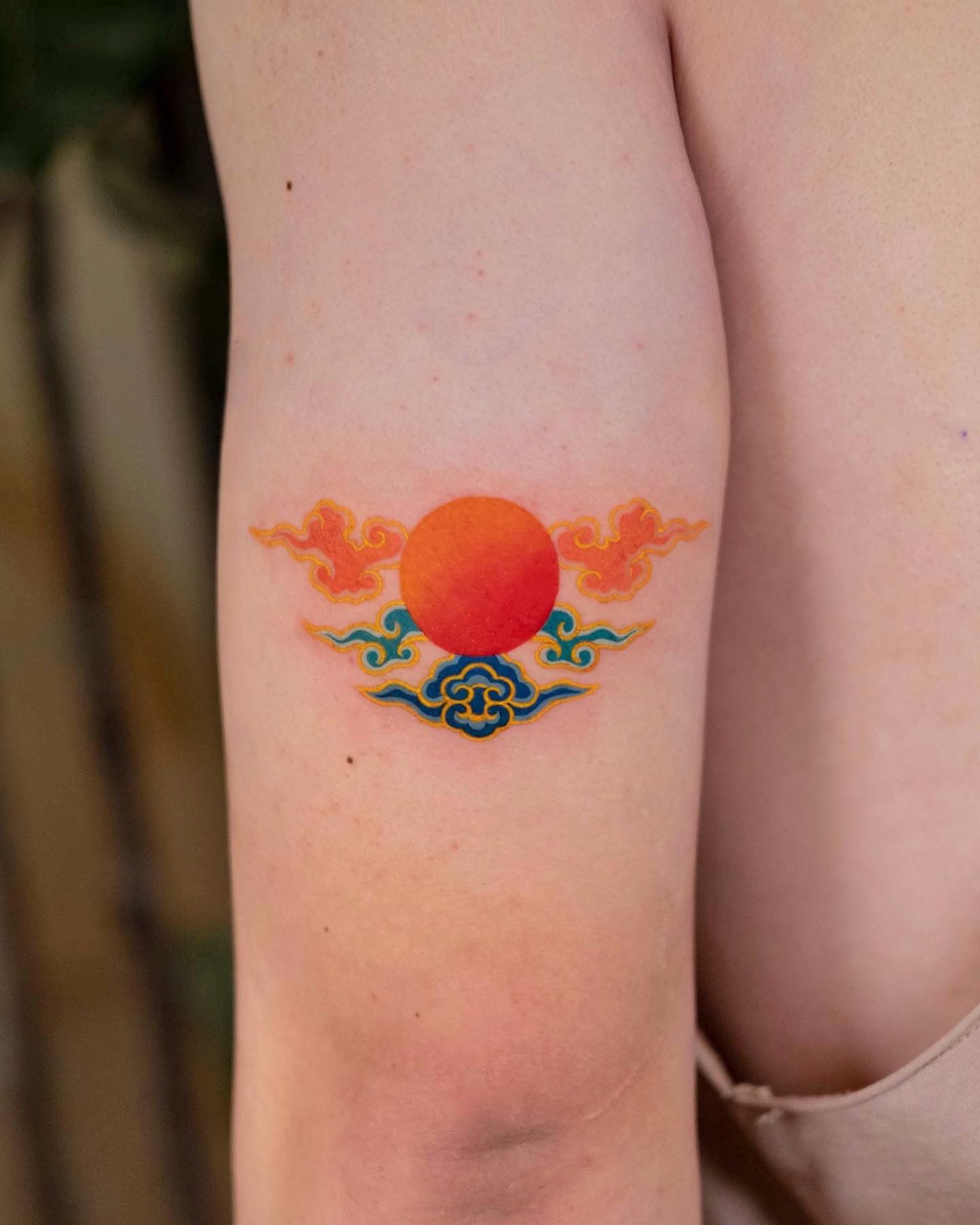 Orange Sun with Blue Clouds Tattoo on Arm