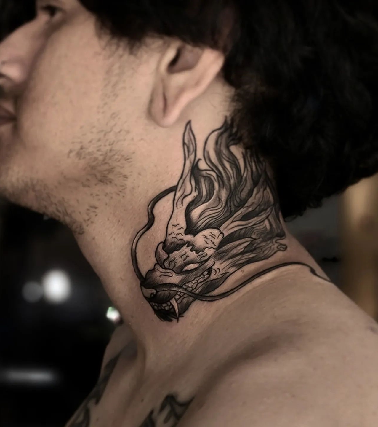 A dragon tattoo on a mans neck  Photo  Lightstock
