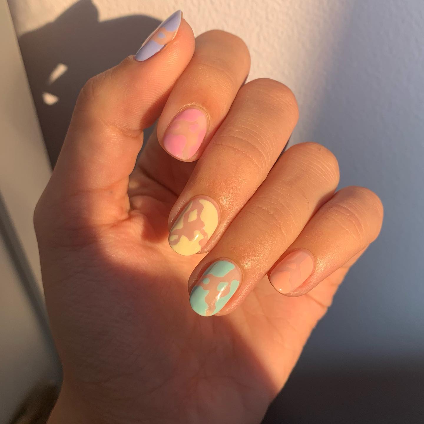 Short Pastel Rainbow Nails with Cow Print Design