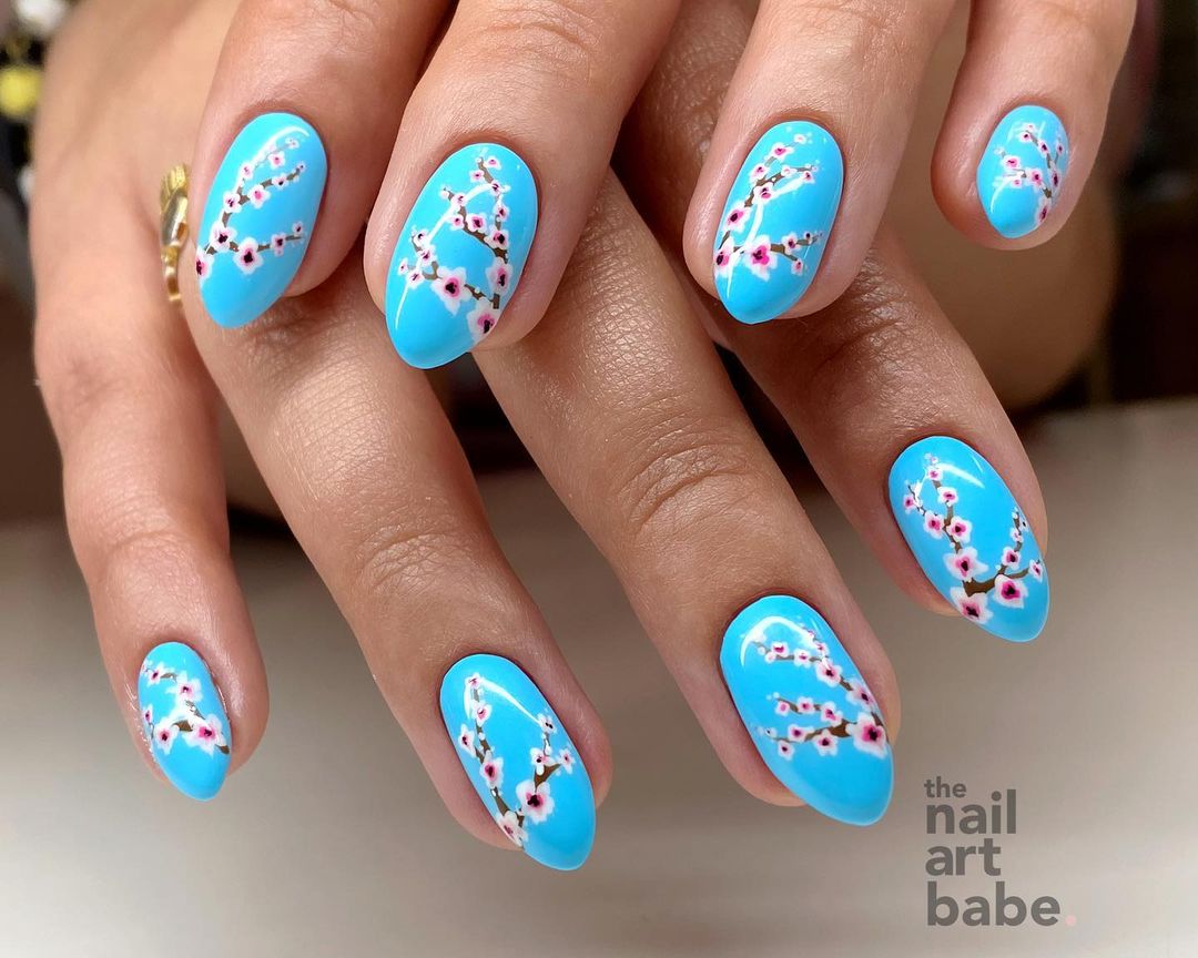 Short Round Blue Nails with Pink Cherry Blossom Design