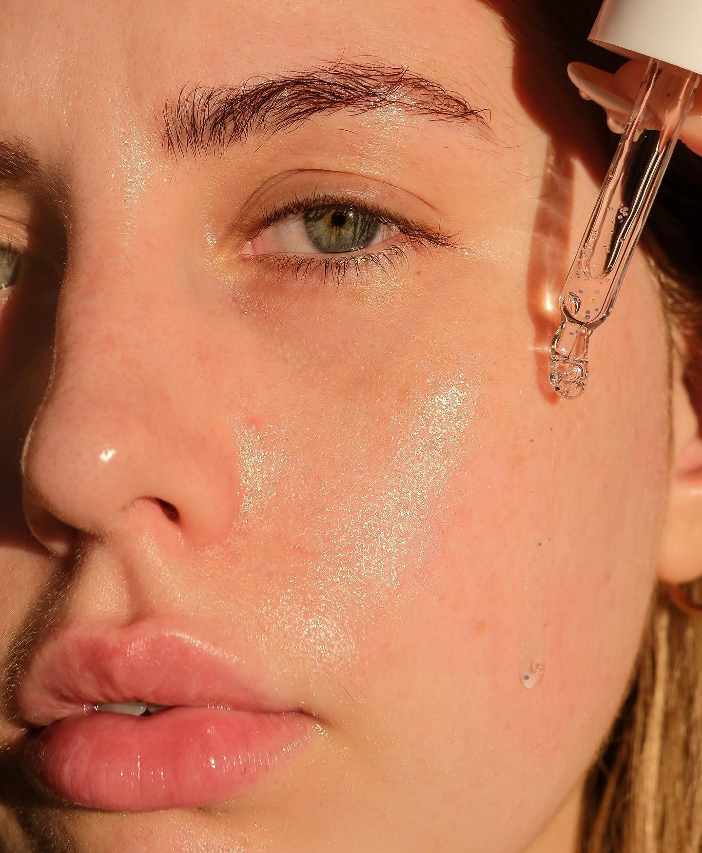 Woman Applying Hyaluronic Acid Serum on Face