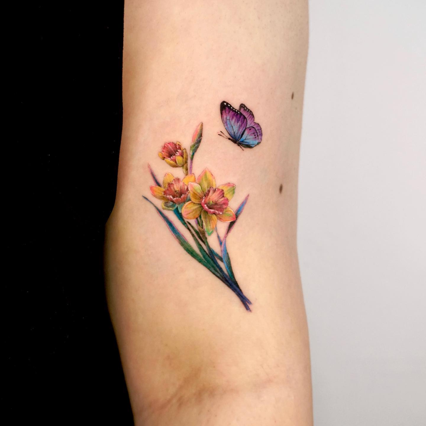 Color Narcissus Flower Tattoo with Butterfly on Arm