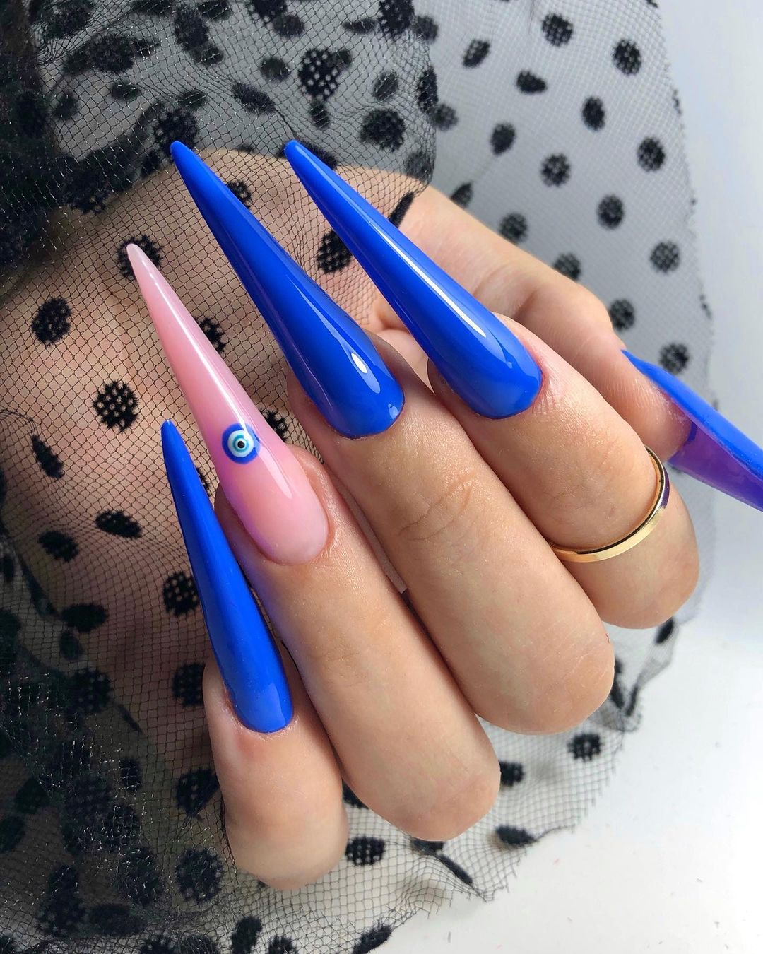 Long Bright Blue Stiletto Nails with Nude Accent Nail