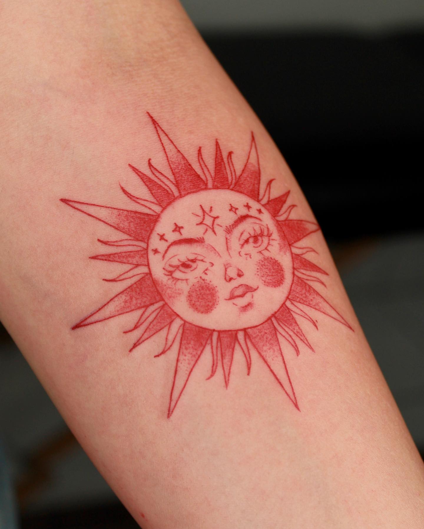 Red Sun with Face Tattoo on Arm