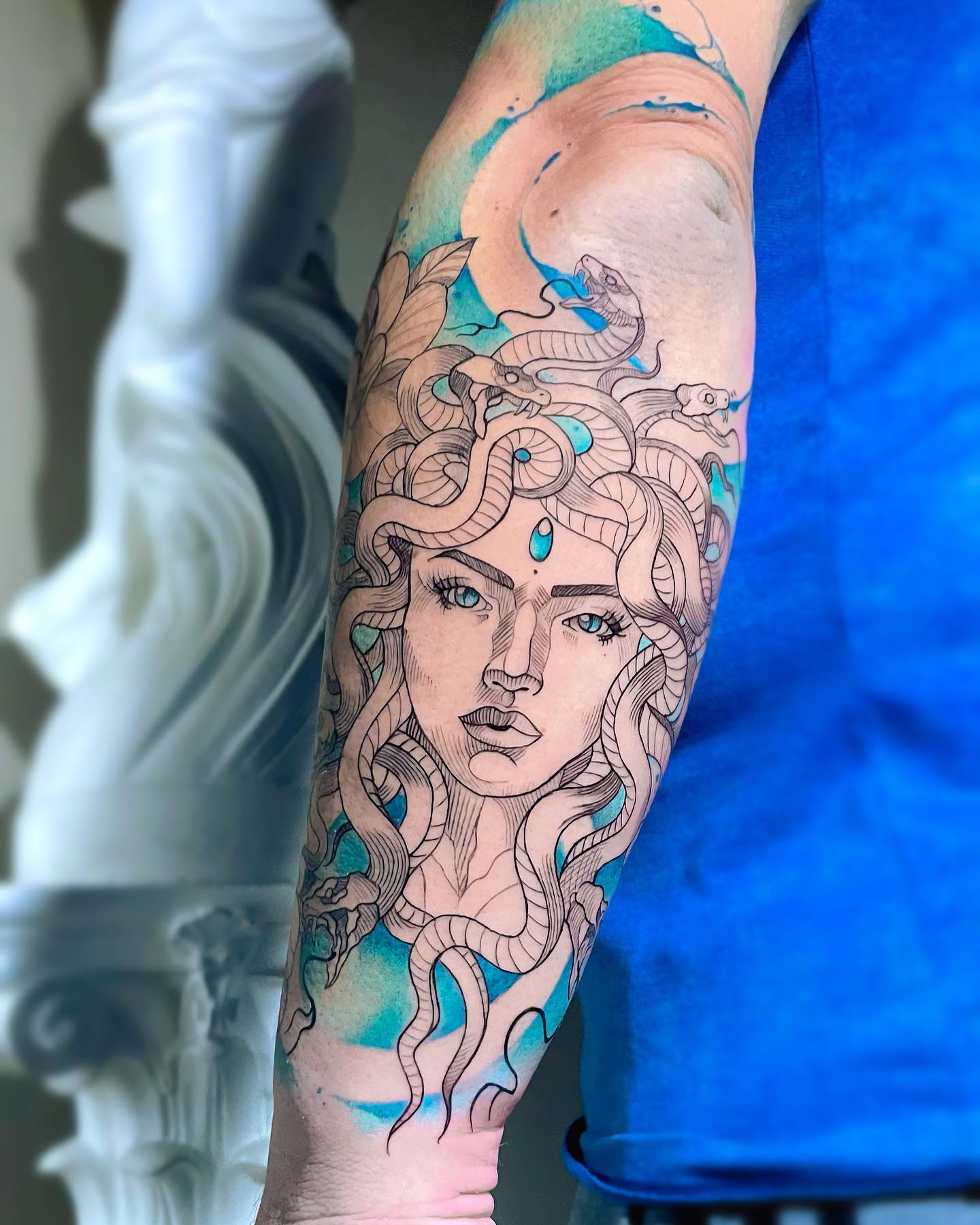 Black and Aqua Menus Tattoo on Arm