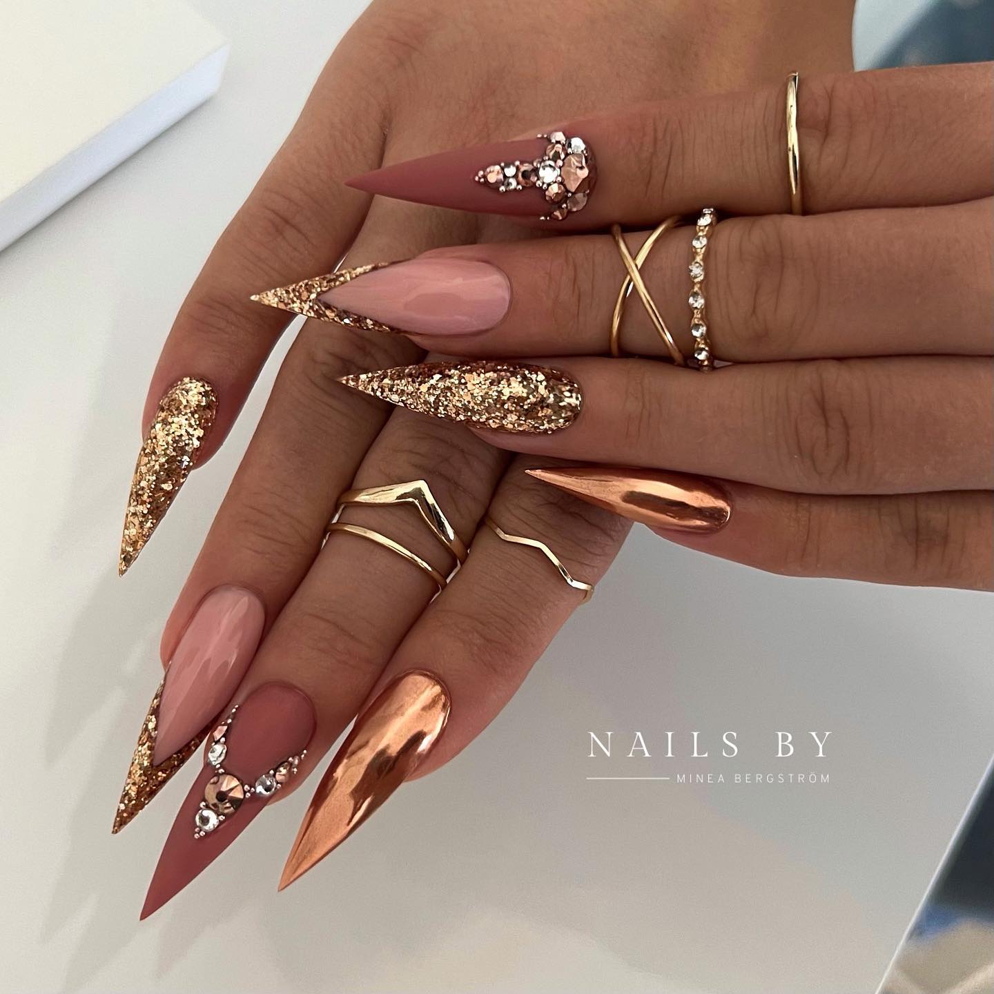 Pointy Brown Nails with Gold Glitter Design
