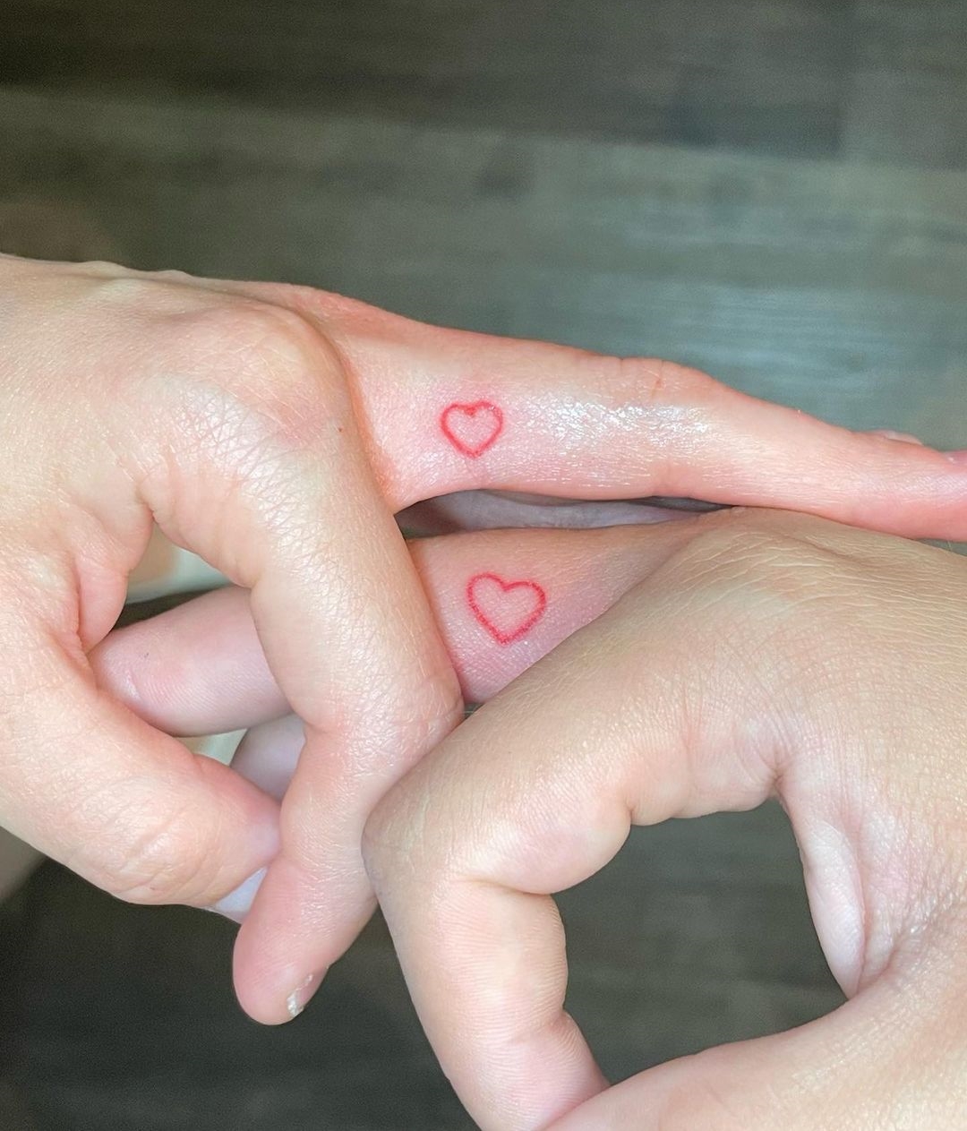 Tiny Red Heart Tattoos on Middle Fingers