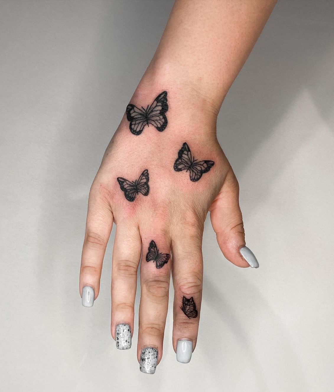 Butterfly Tattoo on Middle and Index Fingers