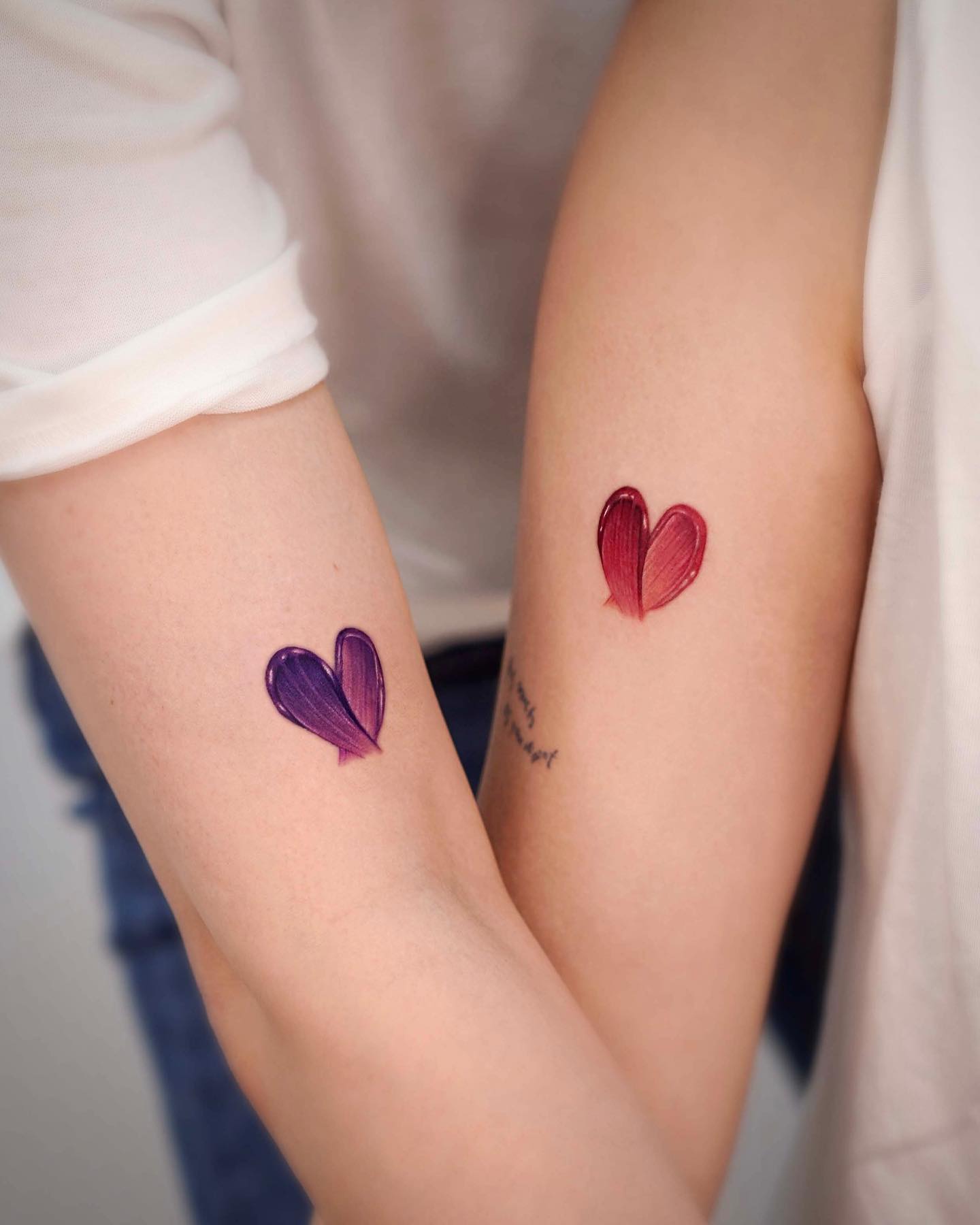Colorful Matching Heart Tattoos on Arms