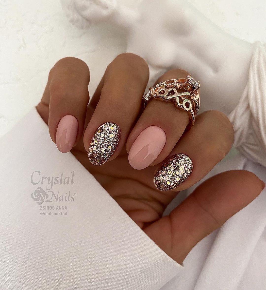 Short Round Nude Nails with Silver Glitter Design