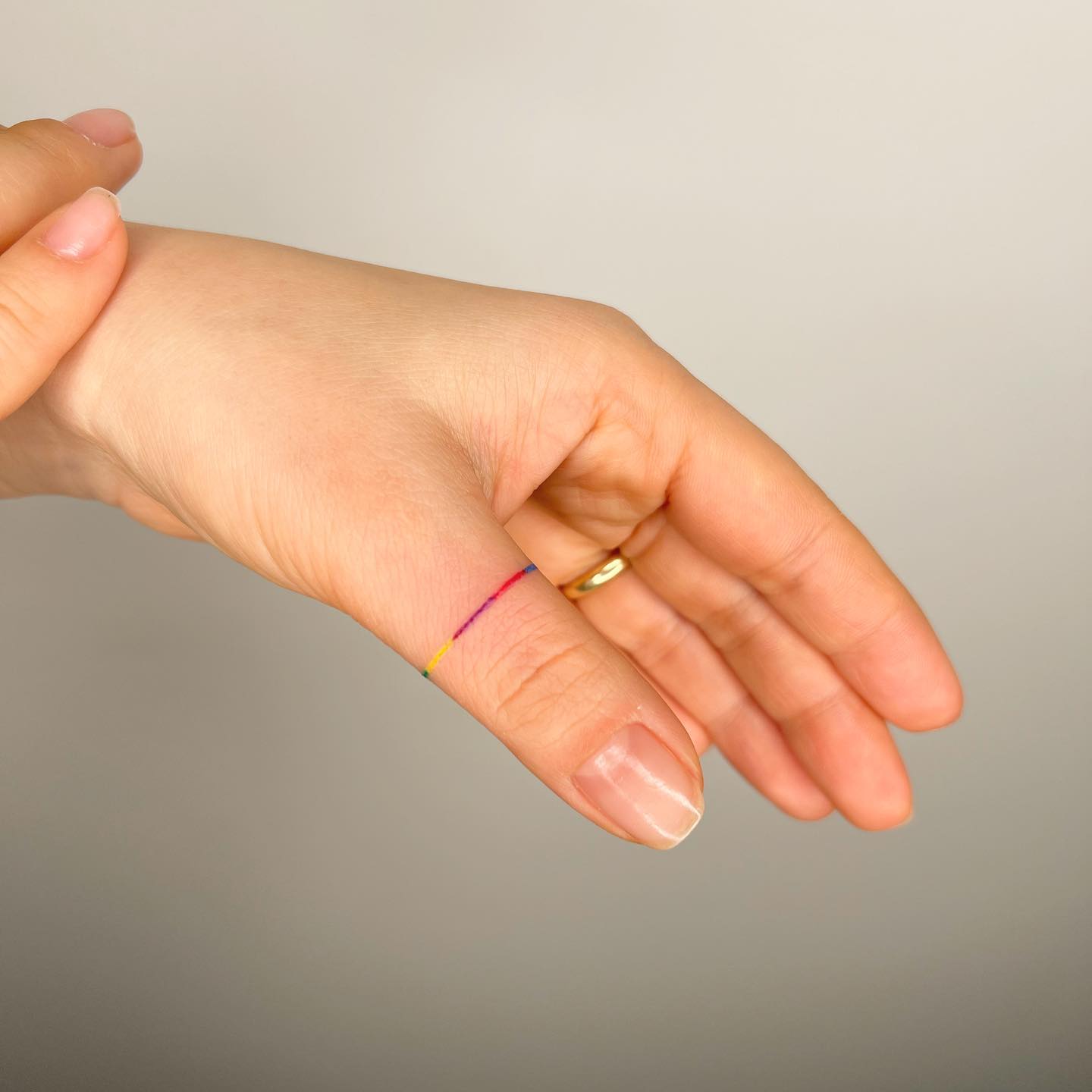 Tiny Ring Tattoo on Thumb