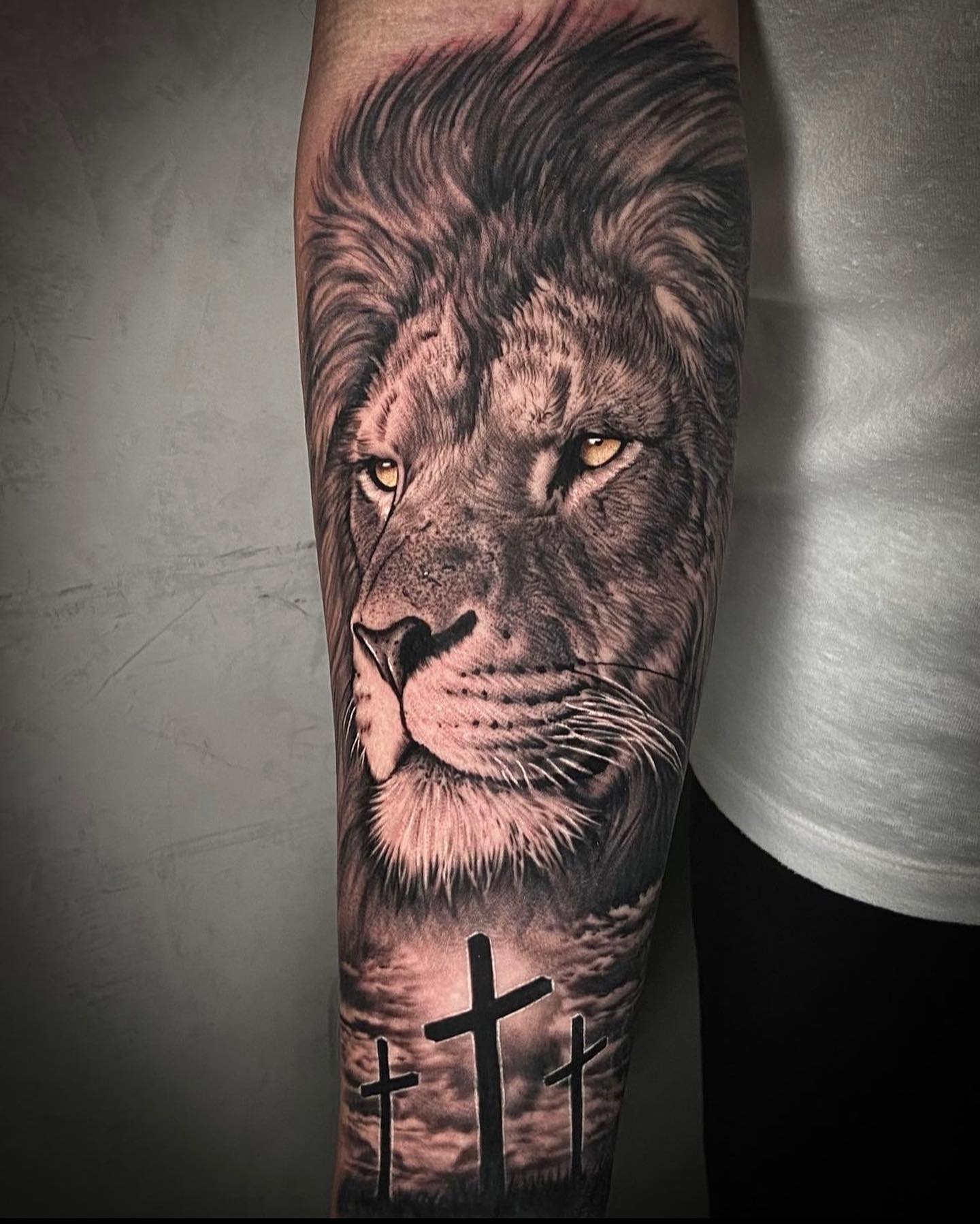Lion Head and Crosses Tattoo