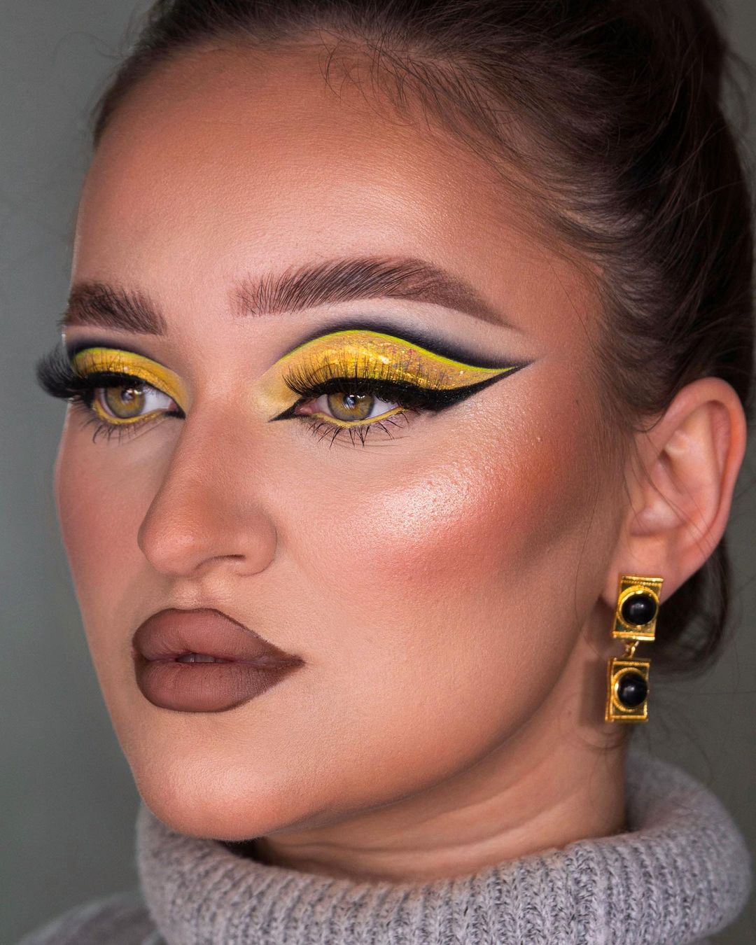 Bright Yellow Eye Makeup with Dark Lines