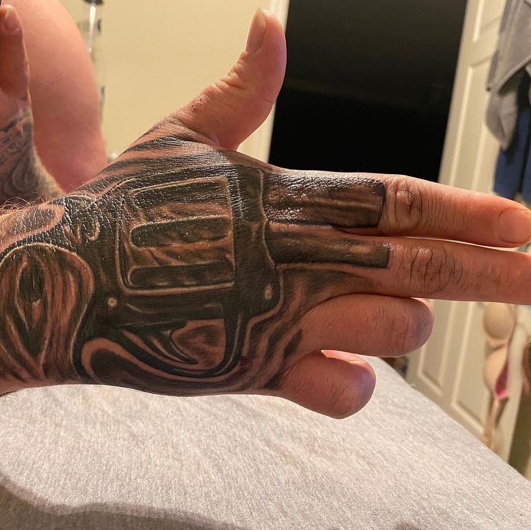 Hand tattoo and gun added to the  Mohawk Tattoo Studio  Facebook