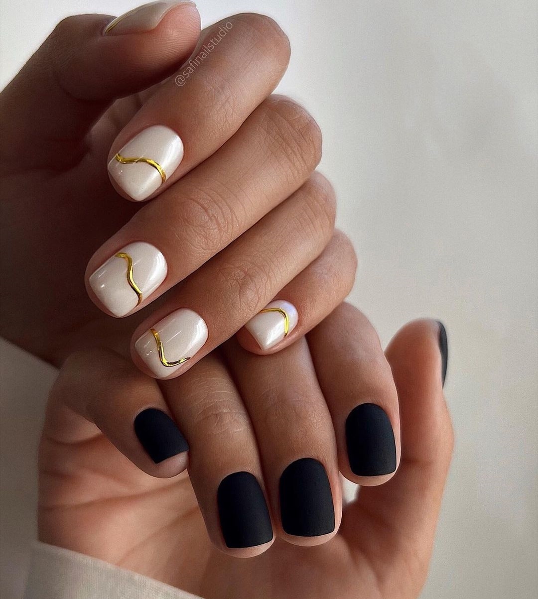 Black and White Nail Design with Gold Lines