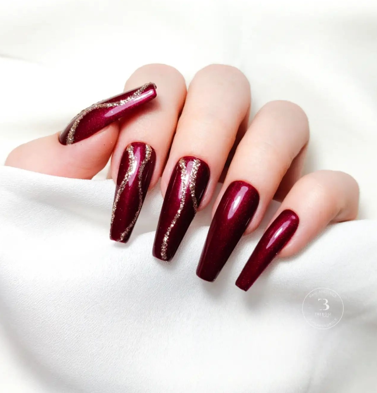 Long Glossy Burgundy Nails with Glitter Gold Lines