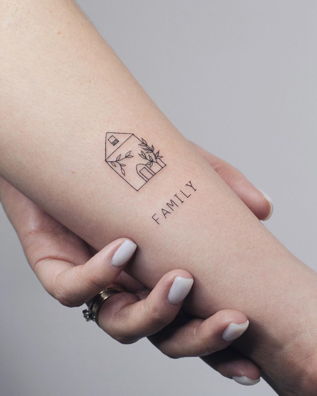 House with Word “Family” Tattoo on Arm