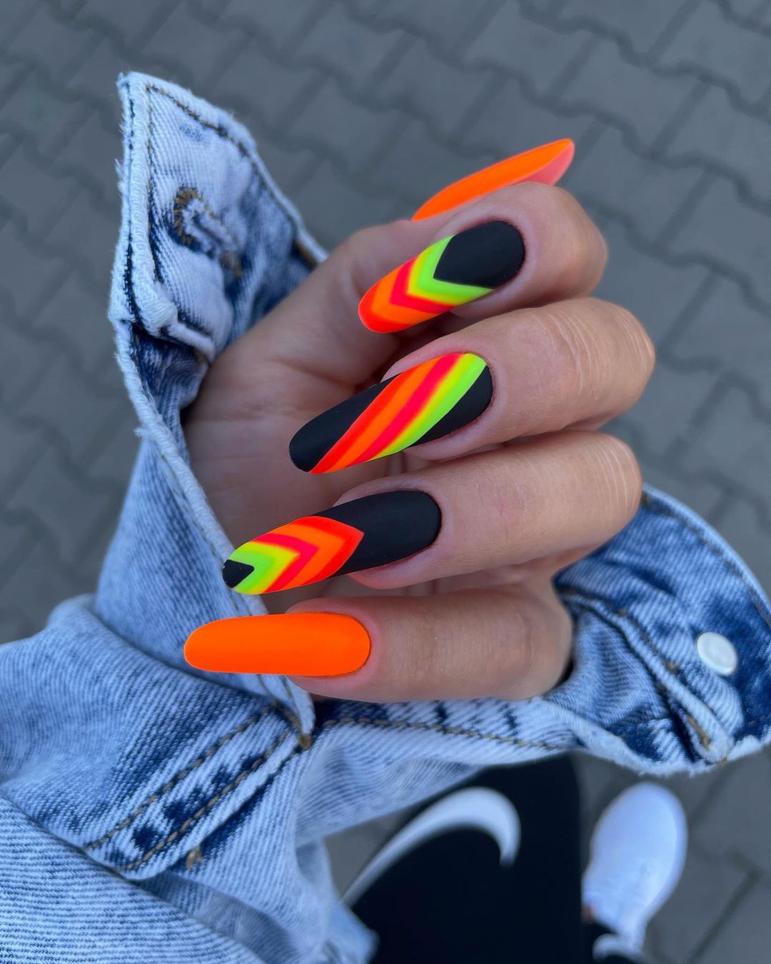 Long Round Black Nails with Orange Neon Design