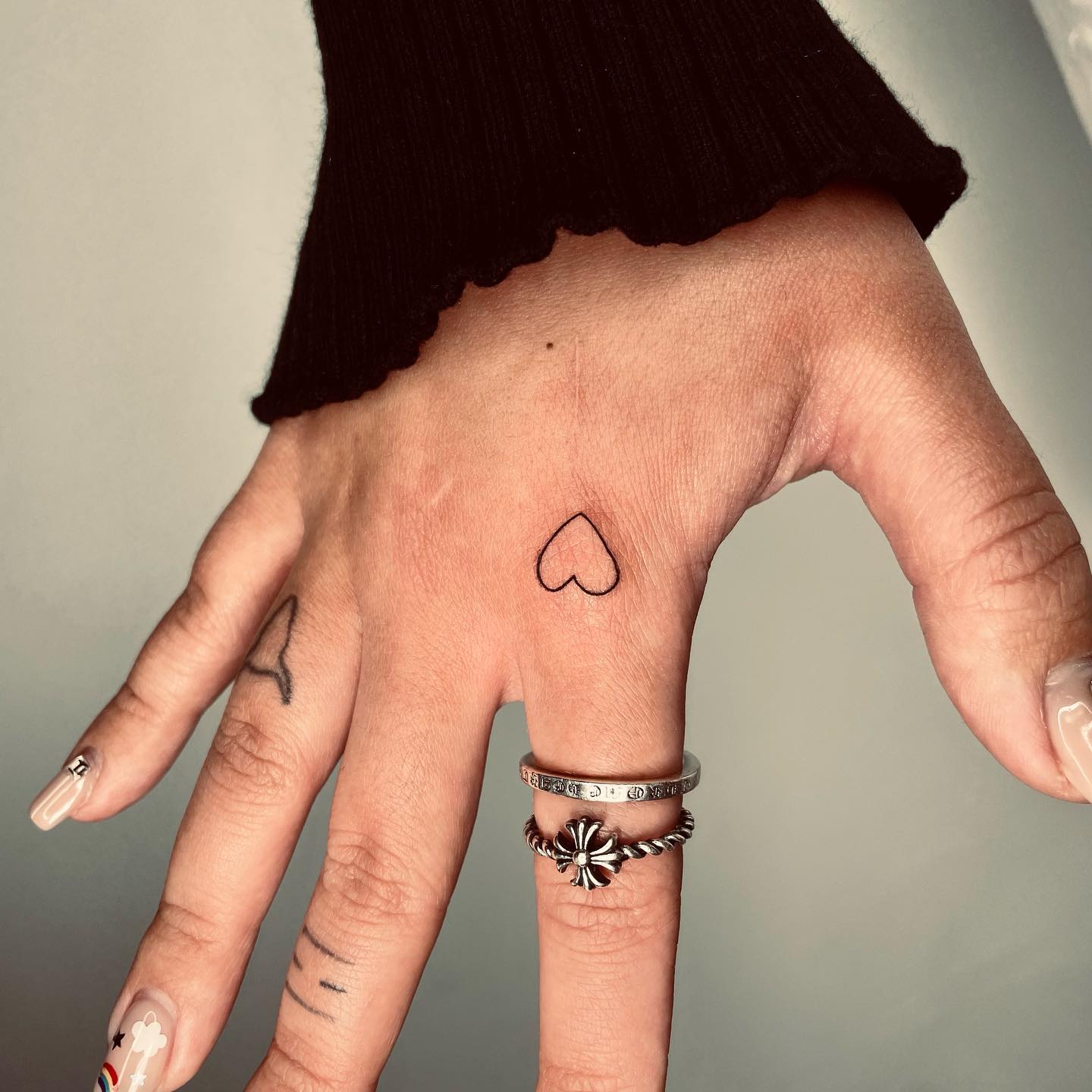 Tiny Heart Tattoo on Index Finger