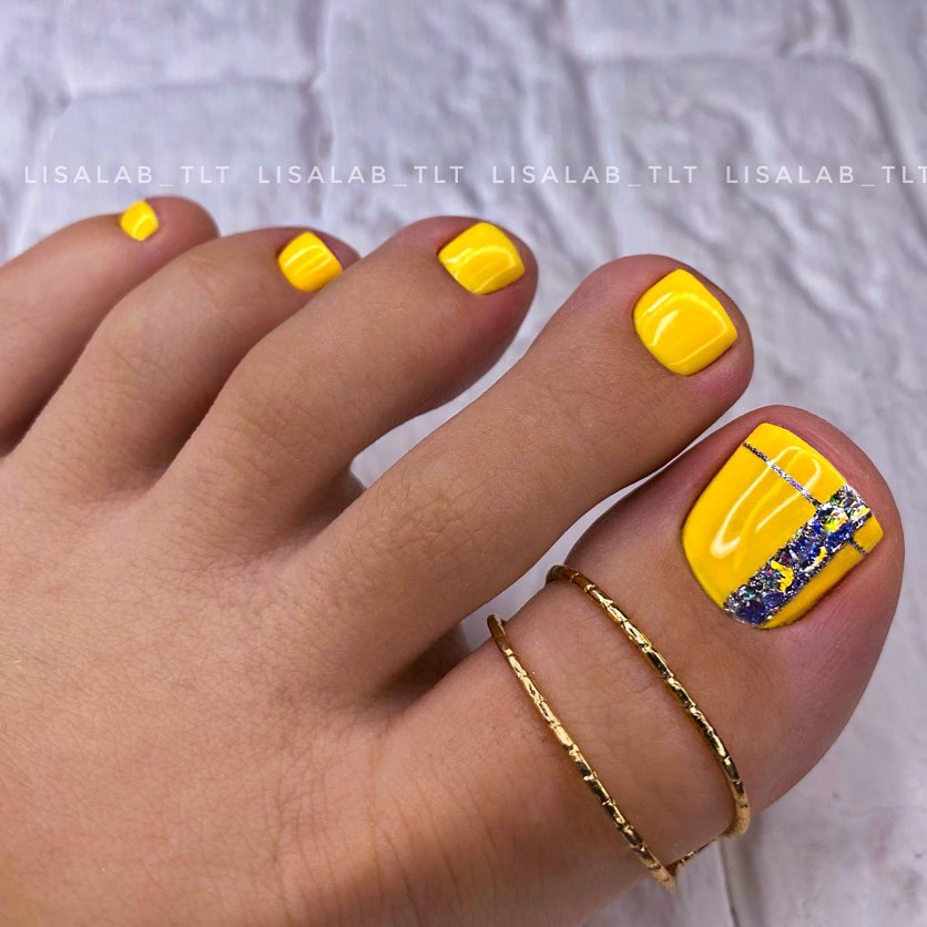 Glossy Yellow Pedicure with Glitter Line on Big Toe