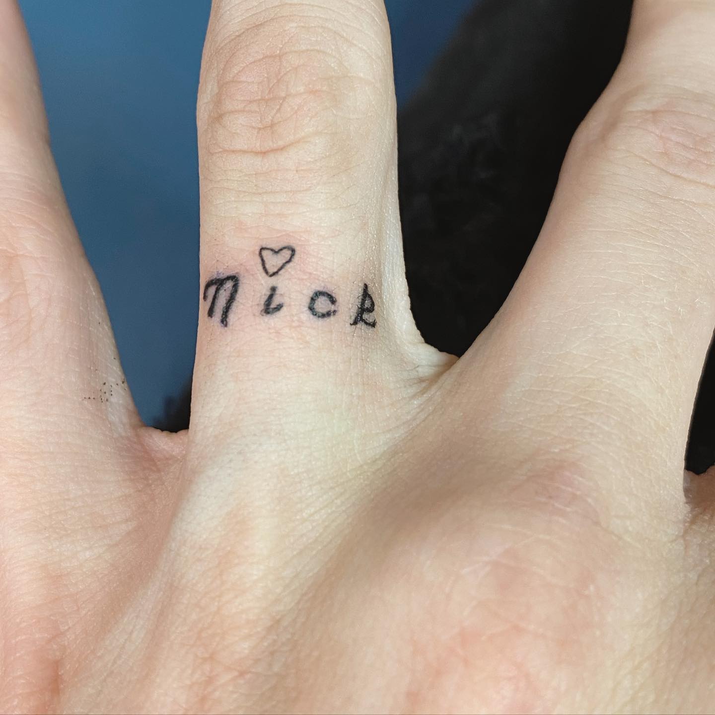 “Nick” Name Tattoo Around Ring Finger