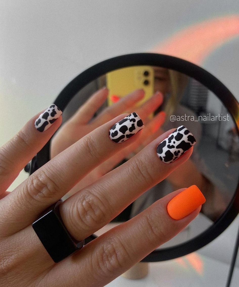 Short Orange Nails with Black and White Cow Print