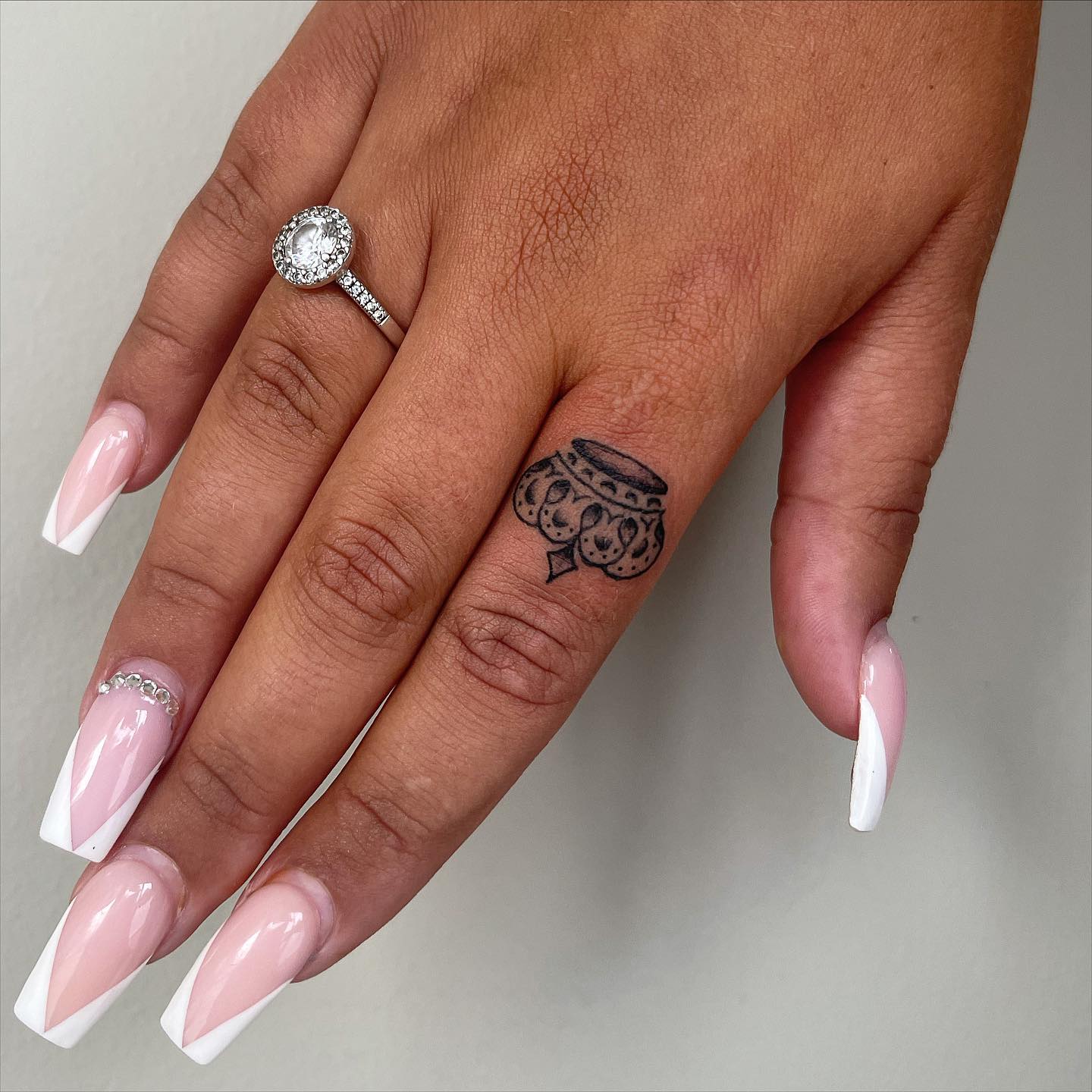 Crown Tattoo on Index Finger for Women