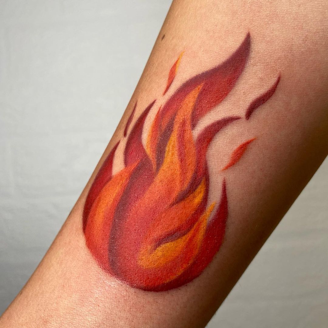 Minimalist fire tattoo on the tricep