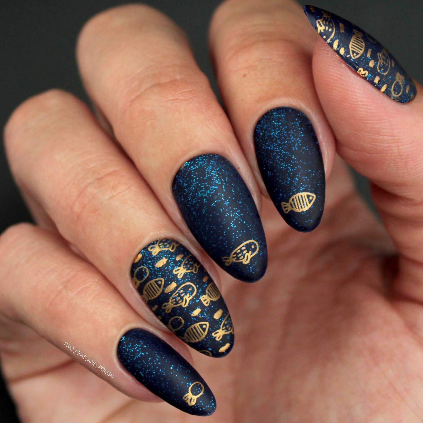 Black Almond Nails with Glitter and Gold Fish Design