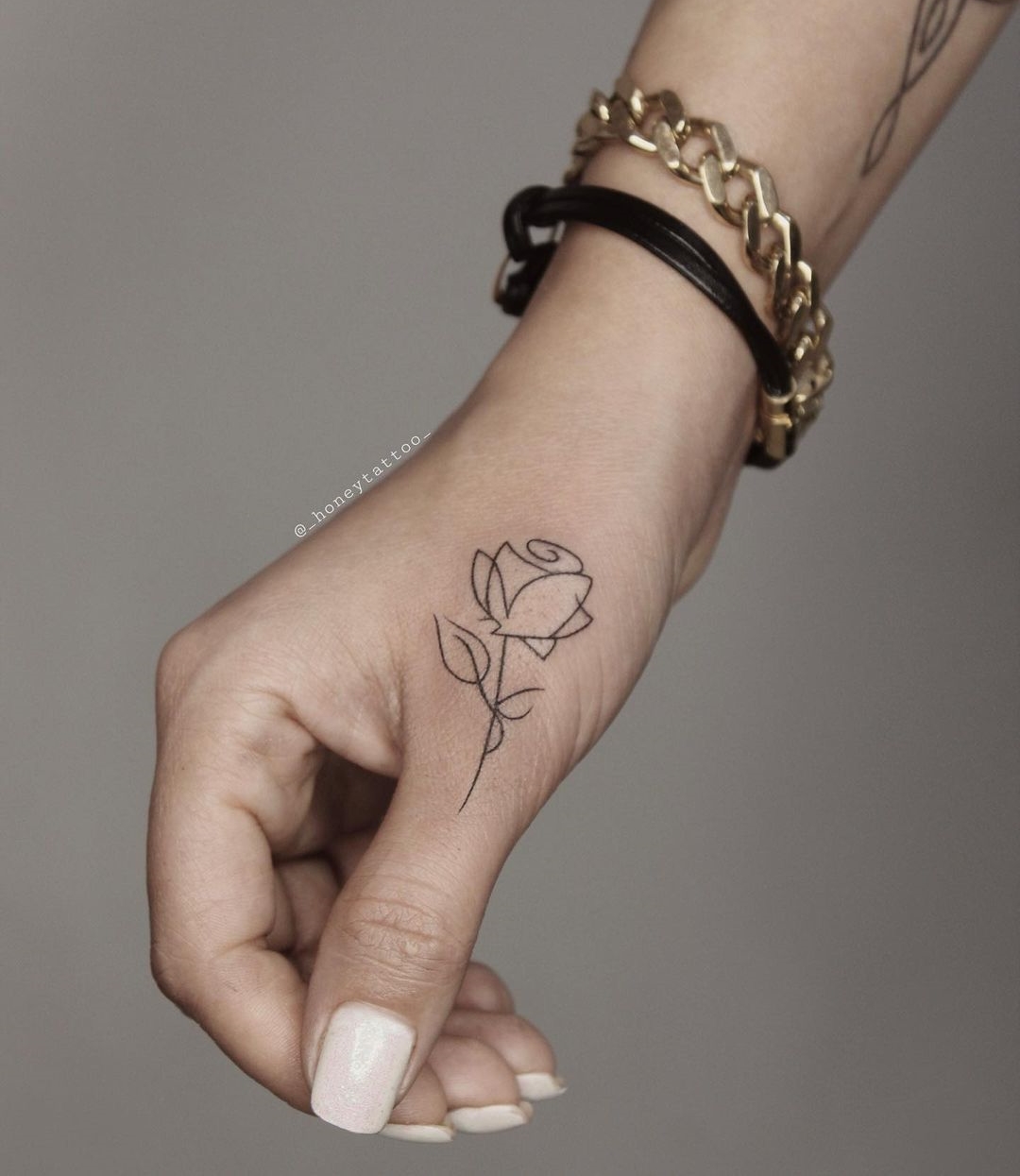 Black and White Rose Tattoo on Thumb