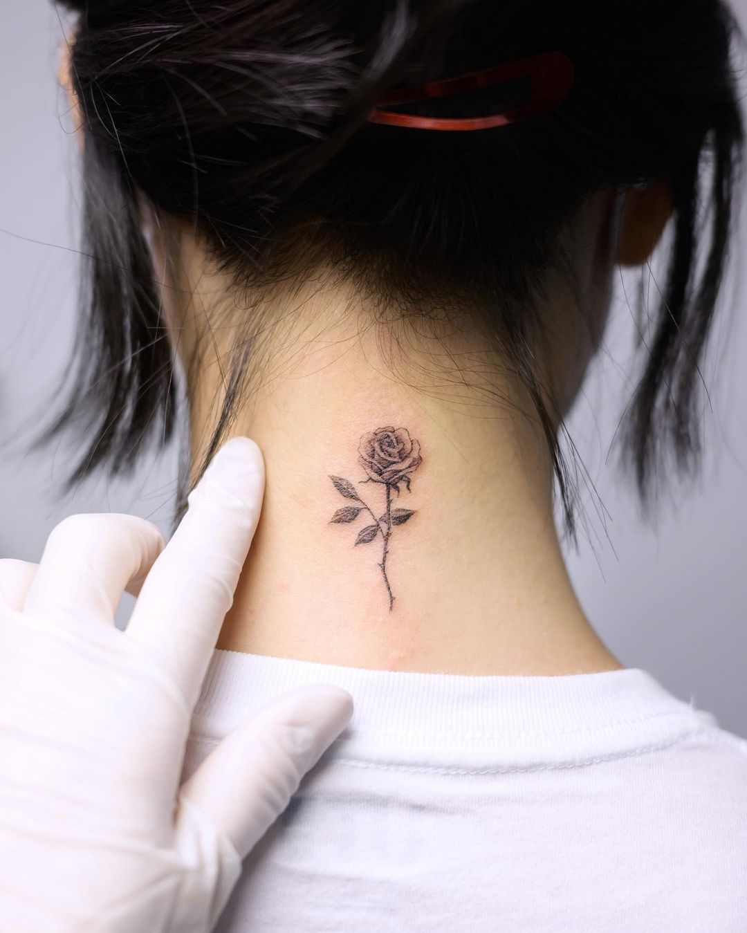 Tiny Rose Tattoo on Neck