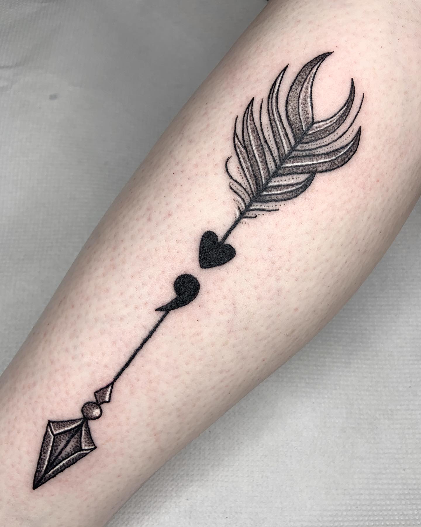 Arrow Tattoo with Semicolon in the Middle