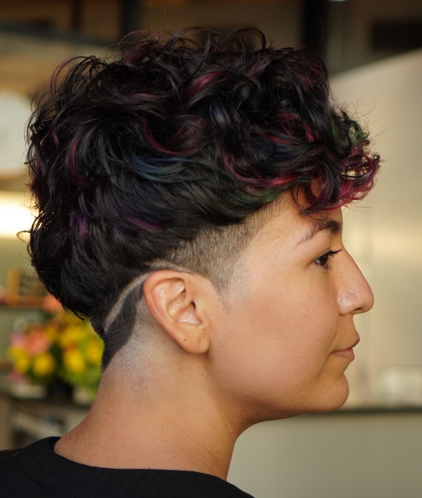 Edgy Curly Pixie on Black Hair with Red Highlights