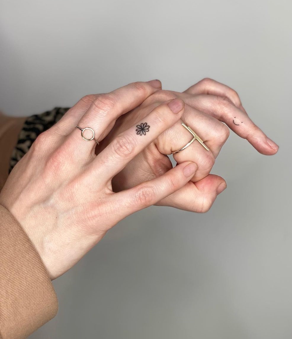 Black and White Tiny Flower Tattoo on Ring Finger