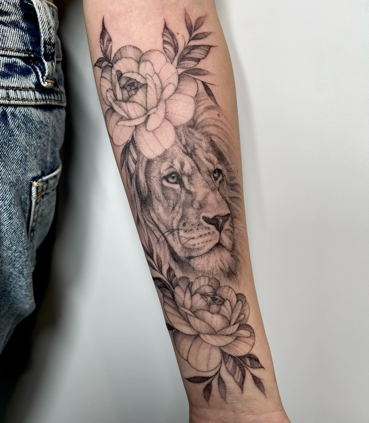 Black Lion Tattoo in Flowers on Arm