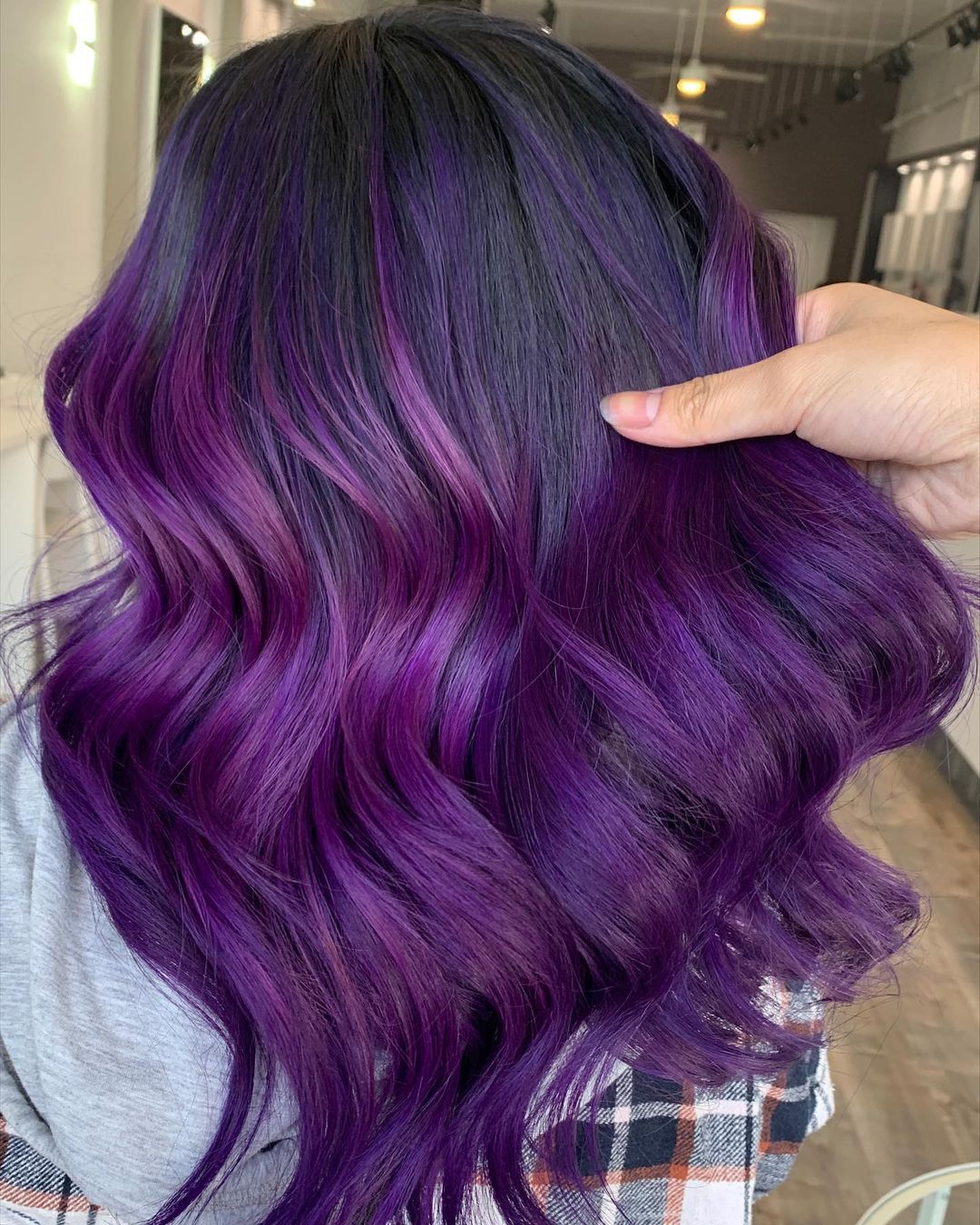 Dark Purple Hues on Black Wavy Hair