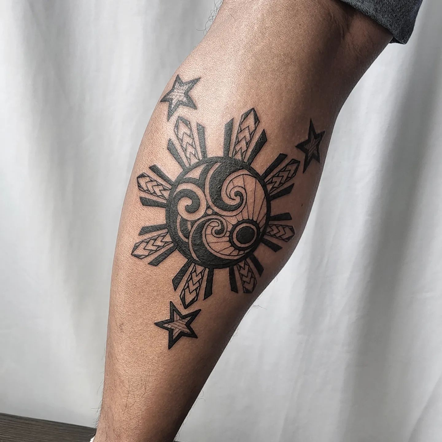 Filipino Sun with Stars Tattoo on Leg