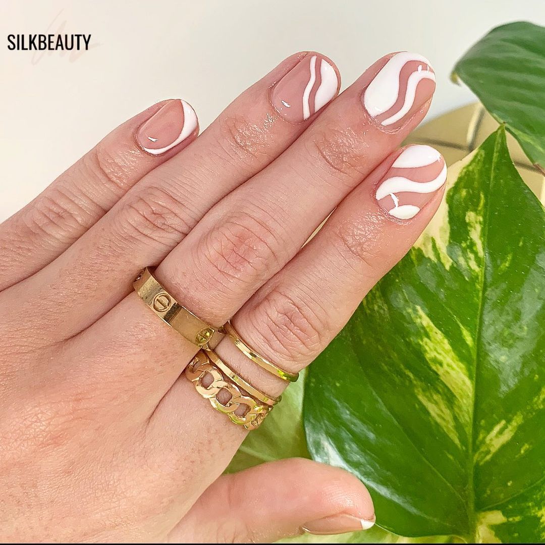 Classic nude and white nail pattern